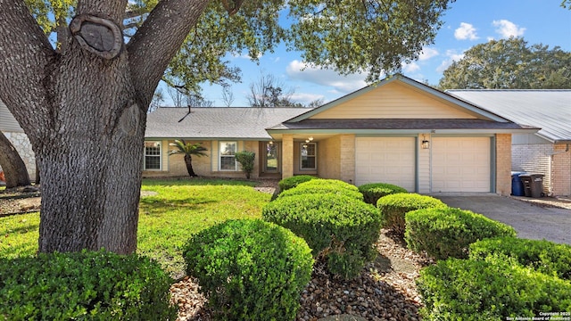 ranch-style home with aphalt driveway, brick siding, a shingled roof, and a garage