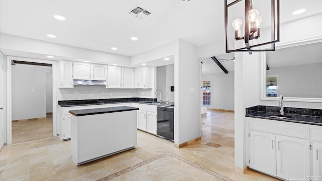 kitchen with under cabinet range hood, a sink, visible vents, dishwasher, and dark countertops