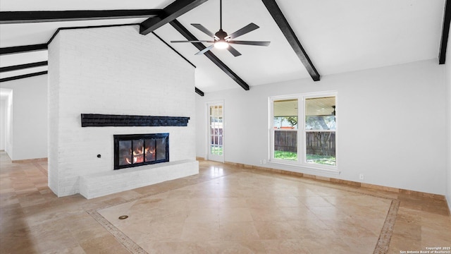 unfurnished living room featuring ceiling fan, a fireplace, baseboards, and beamed ceiling