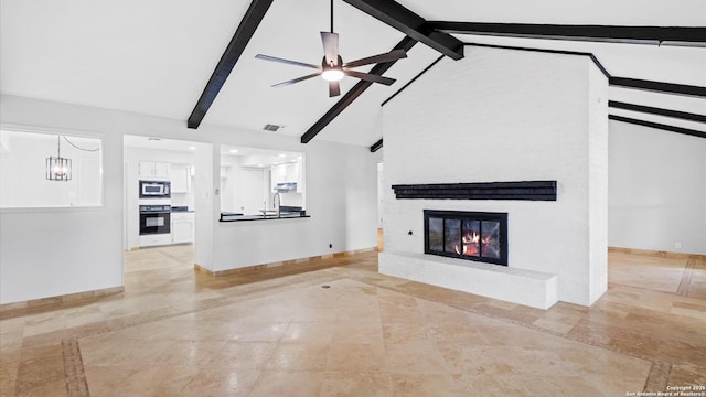 unfurnished living room with visible vents, a fireplace, and baseboards