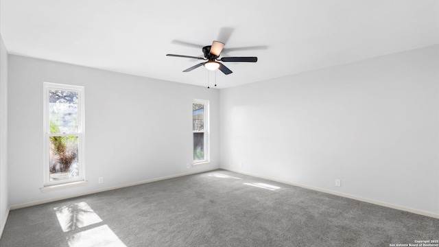 unfurnished room featuring carpet flooring, a ceiling fan, and baseboards