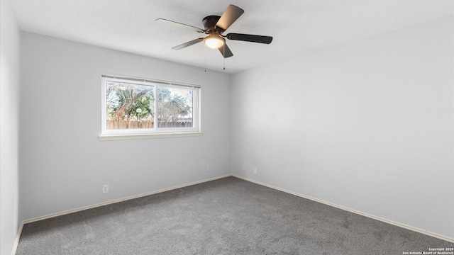 spare room with carpet, baseboards, ceiling fan, and a textured ceiling