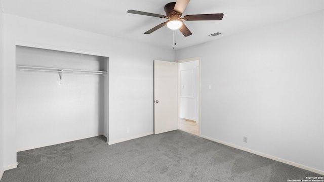 unfurnished bedroom featuring carpet floors, a closet, visible vents, and baseboards