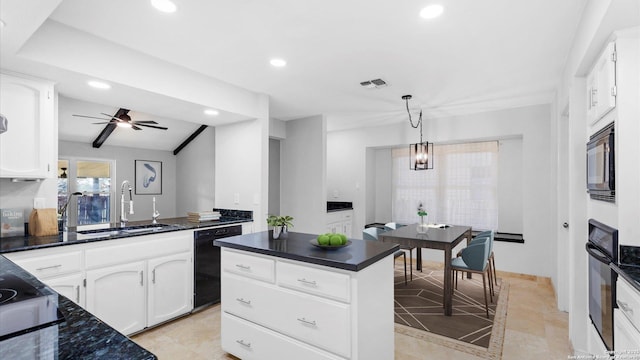 kitchen featuring dark countertops, hanging light fixtures, white cabinets, a sink, and black appliances