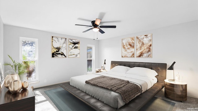 carpeted bedroom with baseboards and a ceiling fan