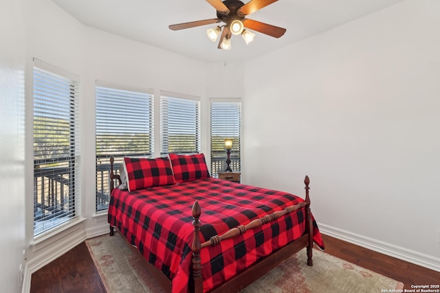 bedroom featuring ceiling fan, baseboards, and wood finished floors