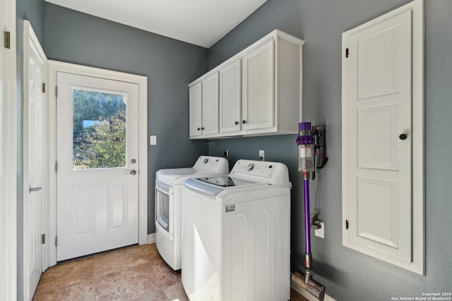 laundry area with cabinet space, washer and clothes dryer, and light tile patterned floors