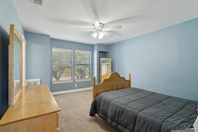 bedroom with carpet floors, visible vents, baseboards, and a ceiling fan