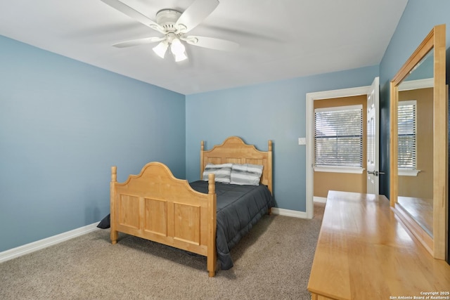 carpeted bedroom with ceiling fan and baseboards