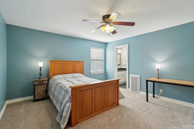 carpeted bedroom featuring visible vents, ceiling fan, baseboards, and ensuite bathroom