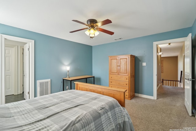 bedroom with light carpet, baseboards, visible vents, and a ceiling fan