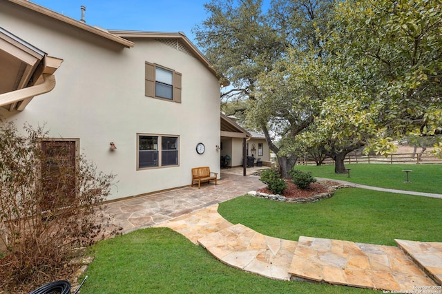 view of yard with fence and a patio