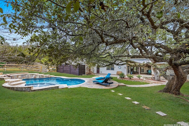 view of pool featuring a lawn, a patio area, and a pool with connected hot tub