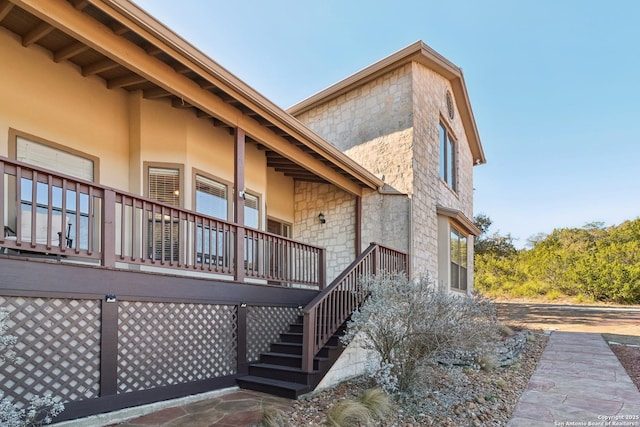 exterior space featuring stairway and stucco siding