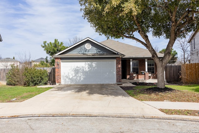 single story home with a garage, concrete driveway, brick siding, and fence