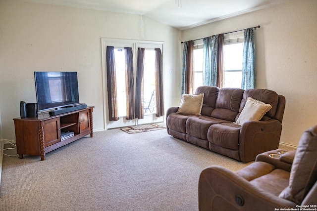 living area with lofted ceiling and light colored carpet