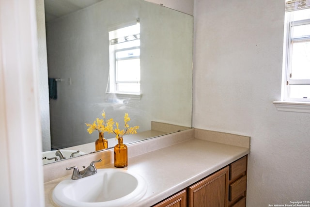 bathroom with a healthy amount of sunlight and vanity