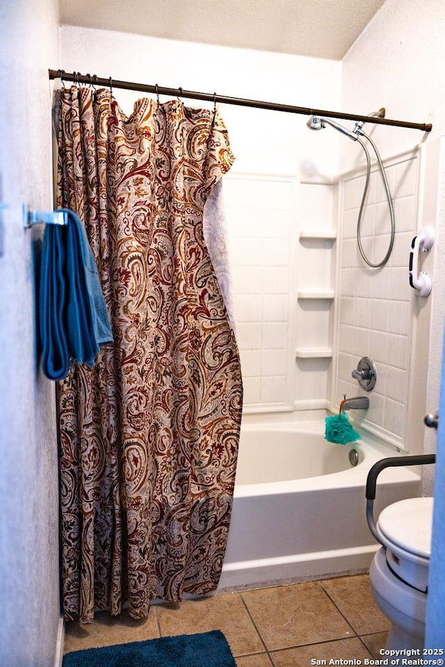 bathroom featuring toilet, shower / bath combo with shower curtain, and tile patterned floors