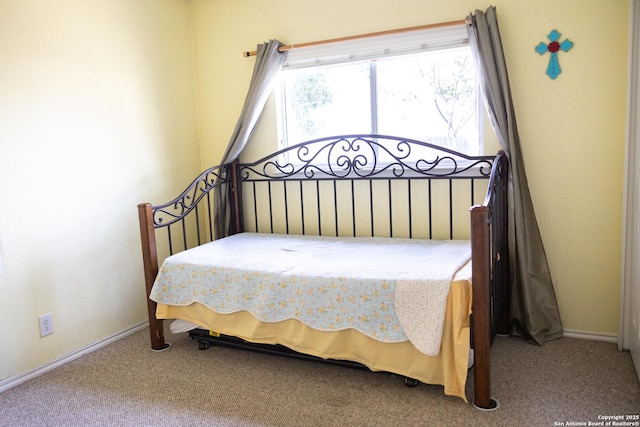 carpeted bedroom featuring baseboards