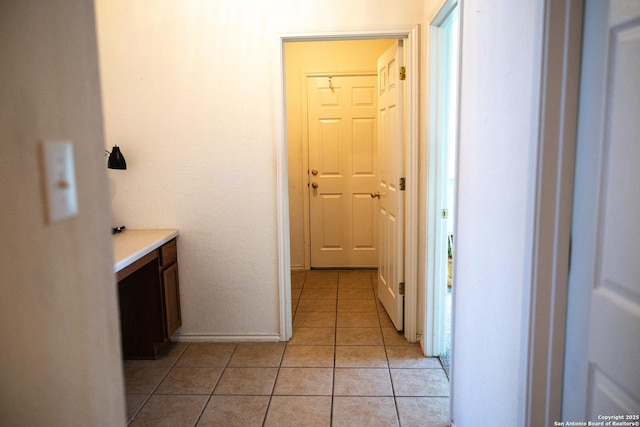 interior space with baseboards and light tile patterned flooring