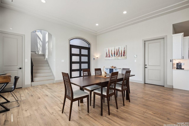 5219 Breeze Way, San Antonio, TX 78249 - dining area with arched walkways, light wood-type flooring, stairs, recessed lighting, and baseboards