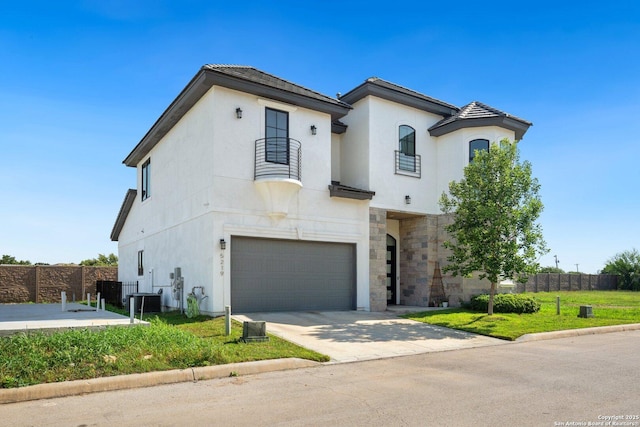 5219 Breeze Way, San Antonio, TX 78249 - view of front of property featuring an attached garage, concrete driveway, stone siding, and stucco siding
