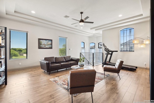 5219 Breeze Way, San Antonio, TX 78249 - living room featuring a tray ceiling, a ceiling fan, light wood-style floors, healthy amount of natural light, and recessed lighting