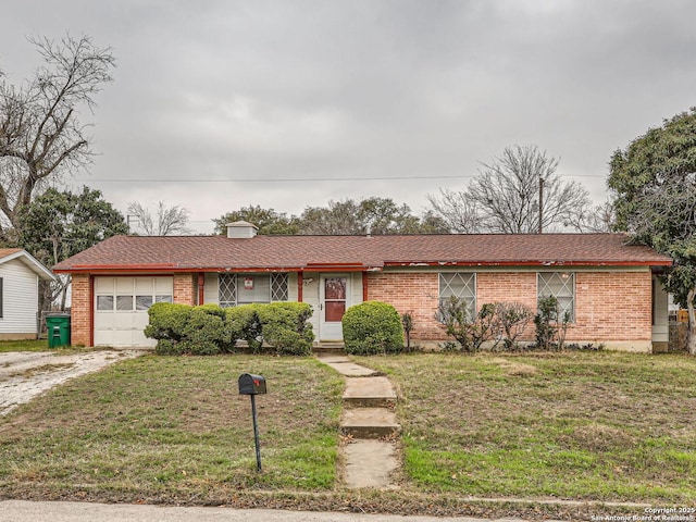 single story home featuring driveway, brick siding, and an attached garage