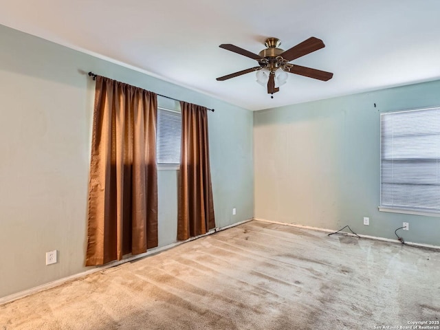 empty room with light colored carpet and ceiling fan