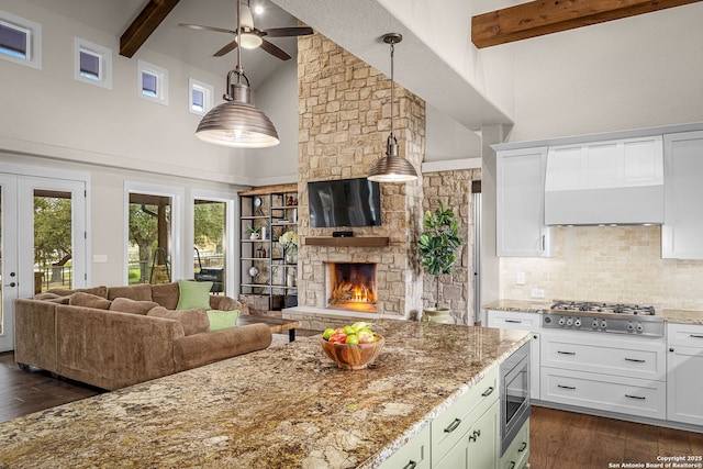 kitchen featuring appliances with stainless steel finishes, white cabinetry, and hanging light fixtures