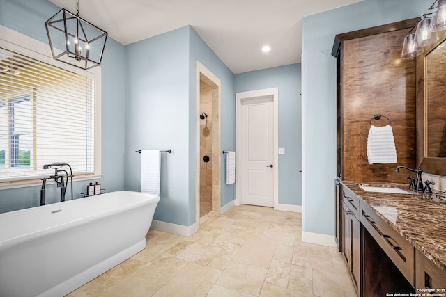 full bathroom featuring recessed lighting, a freestanding bath, a tile shower, vanity, and baseboards