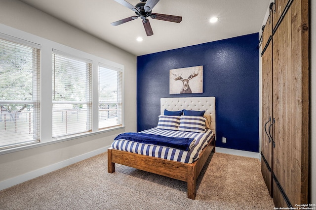 bedroom featuring a textured wall, carpet floors, recessed lighting, and baseboards