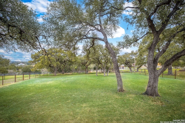 view of yard featuring a rural view and fence