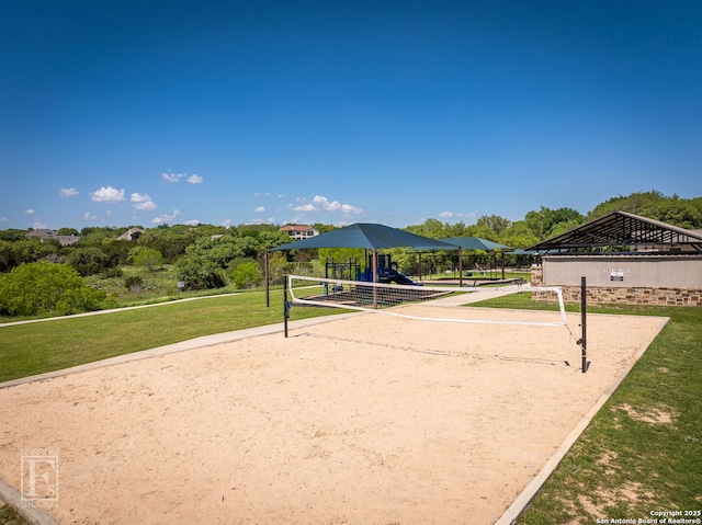 view of home's community featuring a lawn, playground community, and volleyball court