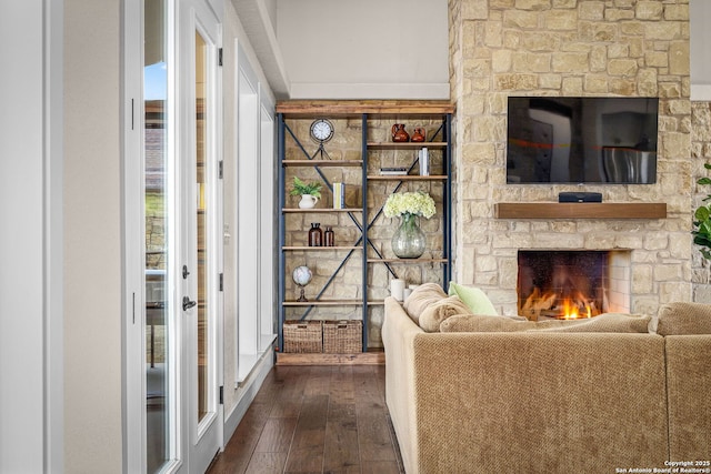 unfurnished living room with dark wood-type flooring and a fireplace