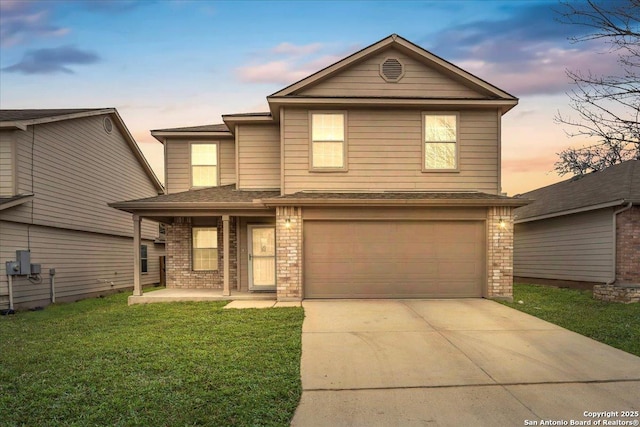 traditional-style home with brick siding, a yard, a porch, concrete driveway, and an attached garage