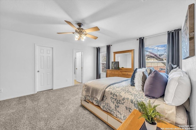 carpeted bedroom with ceiling fan and baseboards