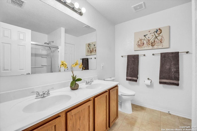 bathroom featuring visible vents, a sink, and an enclosed shower