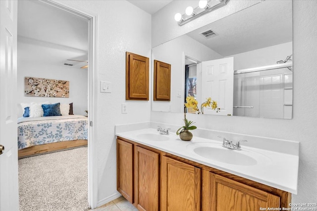 bathroom with a sink, double vanity, ensuite bath, and visible vents