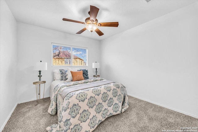 bedroom with ceiling fan, carpet flooring, and baseboards