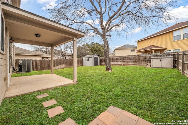 view of yard featuring a patio, a shed, central AC, and a fenced backyard