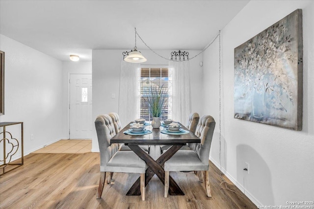 dining room featuring baseboards and wood finished floors