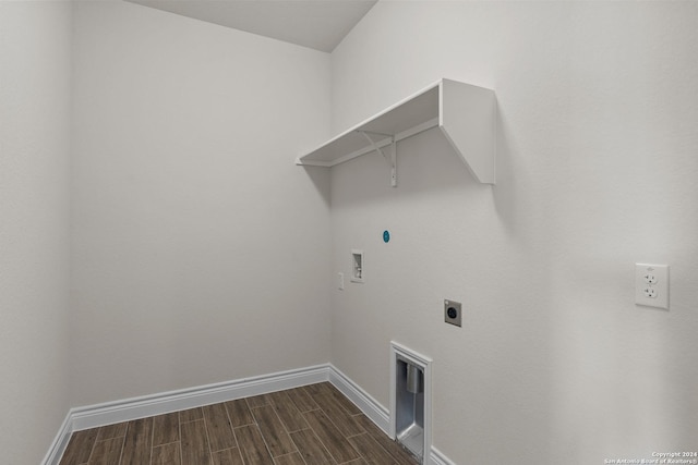 clothes washing area featuring hookup for a washing machine, wood tiled floor, electric dryer hookup, laundry area, and baseboards