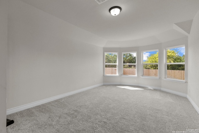 unfurnished room featuring carpet and baseboards