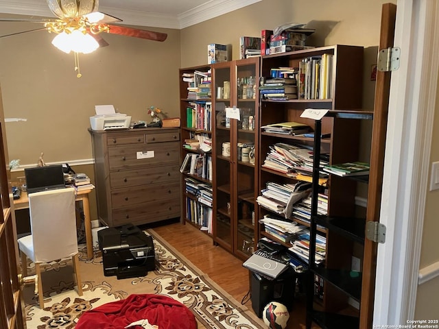 office featuring ornamental molding, light wood-type flooring, and a ceiling fan