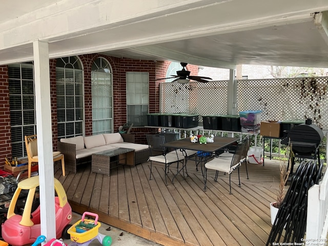 deck featuring outdoor dining area, outdoor lounge area, and a ceiling fan