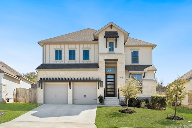 view of front of property featuring fence, roof with shingles, a front lawn, concrete driveway, and a garage