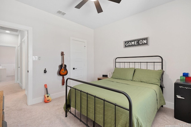 bedroom featuring a ceiling fan, baseboards, visible vents, and light carpet