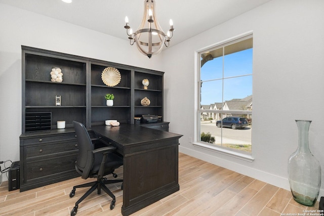 office featuring baseboards, a chandelier, and light wood finished floors