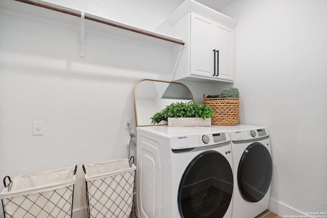 laundry room with cabinet space and washing machine and dryer